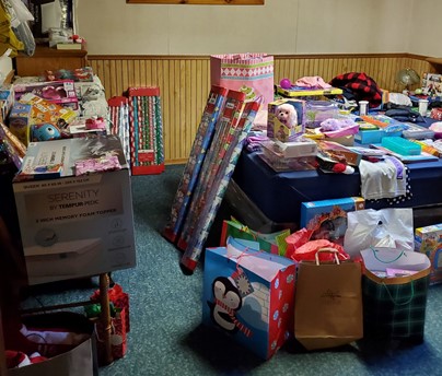 Shows a room filled with donations and gifts
