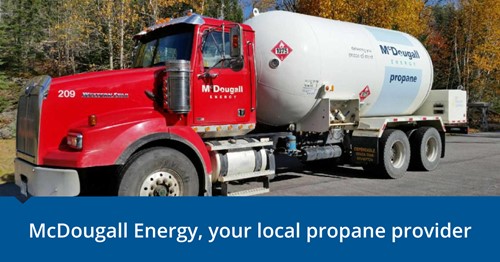 Shows outside image of a large red and white McDougall Energy fuel truck