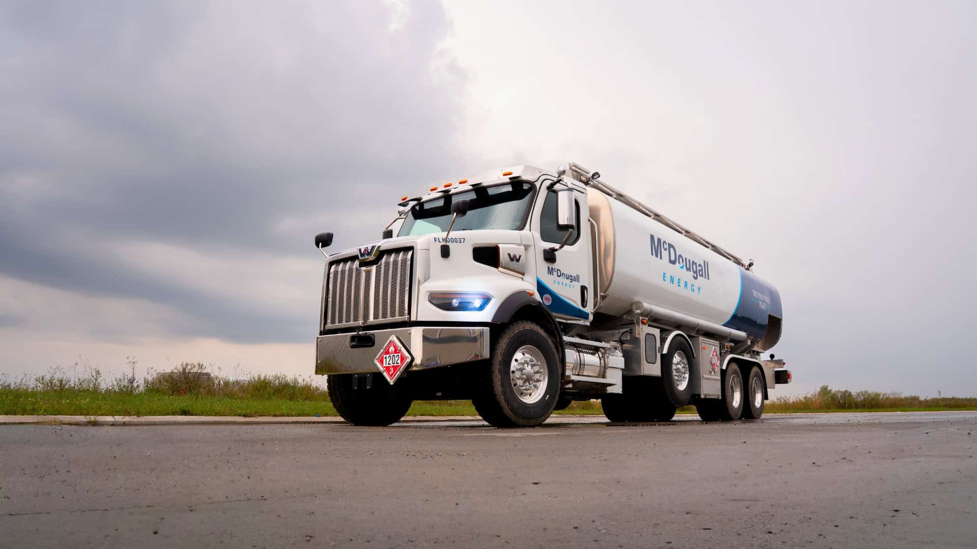 Fuel delivery truck with McDougall Energy branding on a rural road in Ontario.