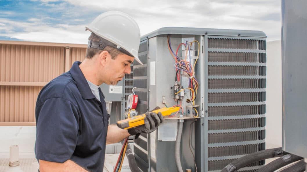 HVAC technician inspecting and repairing an air conditioning unit for residential comfort.