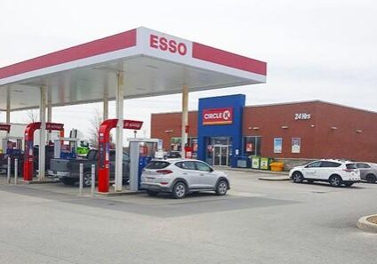 Shows exterior of Esso gas station and Circle K building behind it