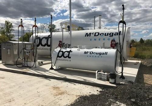 Shows outdoor shot of large white tank with Mcdougall Energy logo on it and BCT logo