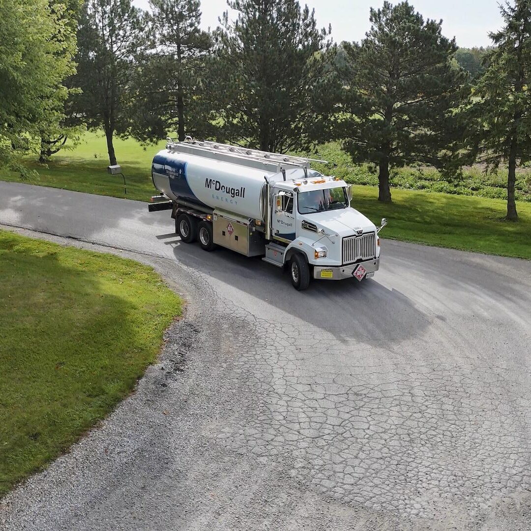 Oil delivery truck from McDougall Energy on a rural road.