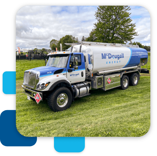 Gas fuel truck with McDougall Energy logo in a grass field