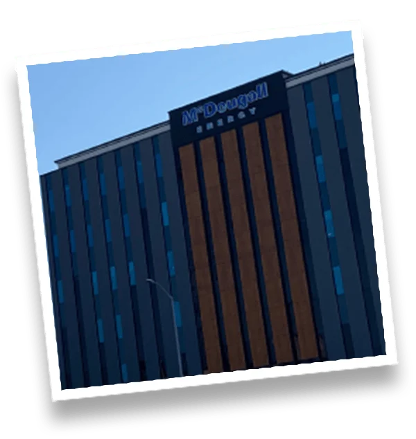 Modern McDougall Energy building with blue and brown exterior, showcasing energy industry facilities.